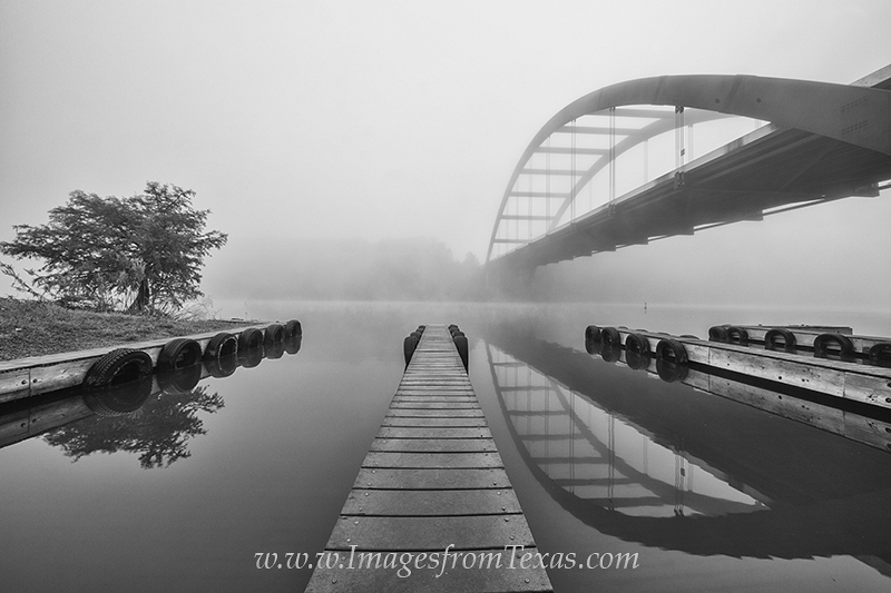Boat Ramp at the 360 Bridge Black and White 1 The wooden planks of a boat ramp stretch into the calm water near the 360 Bridge. This Austin icon has been photographed many...