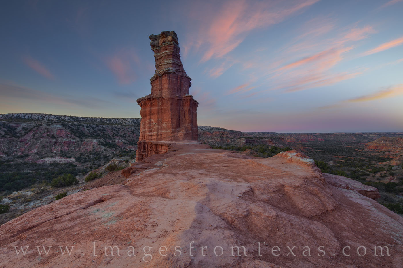 December Sunset over the Lighthouse 1212-1 On a cool December evening, soft clouds light up in pastel pink and blue over the iconic Lighthouse in Palo Duro Canyon.