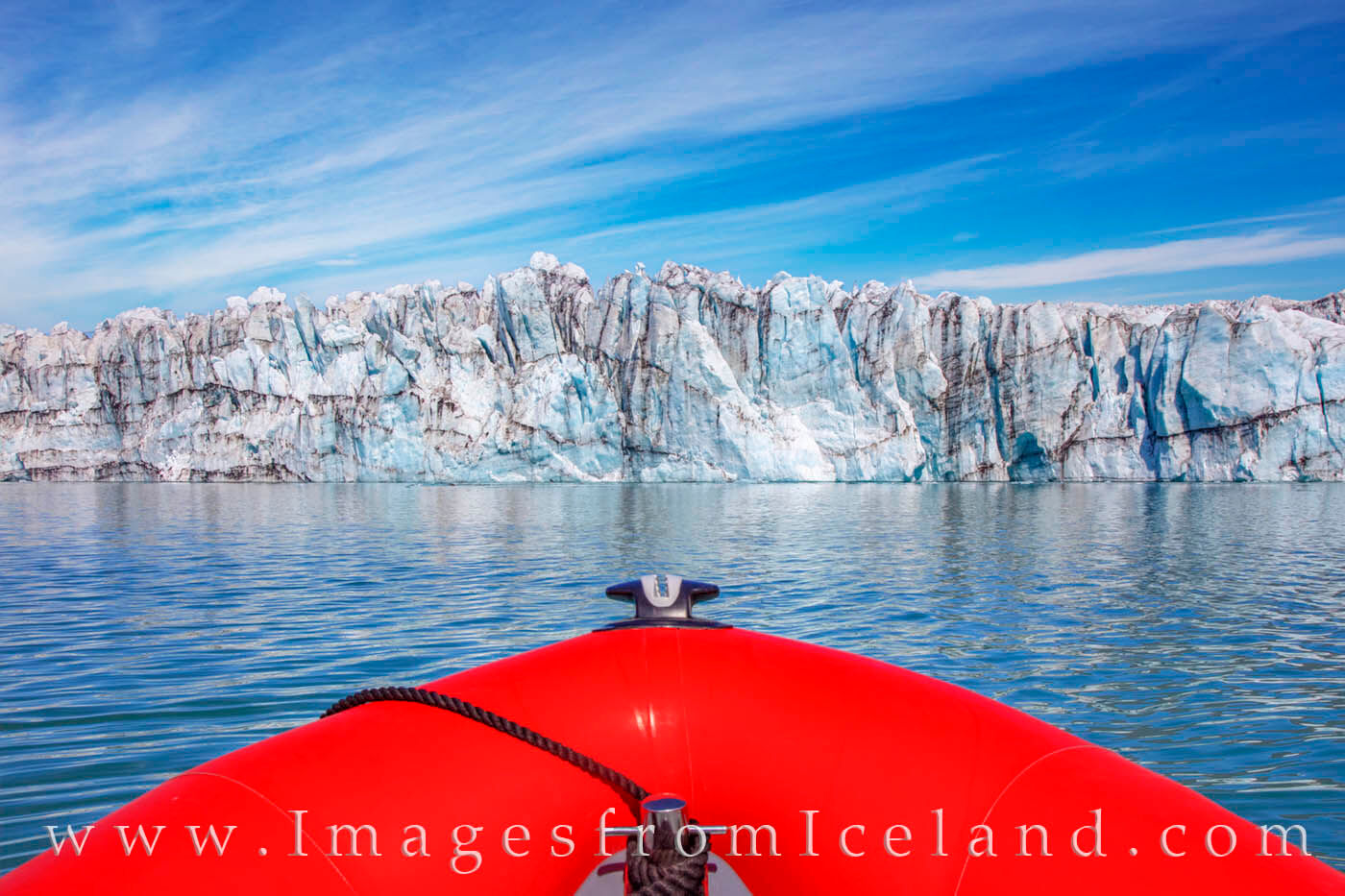 Facing Breiðamerkurjökull Glacier 1 Breiðamerkurjökull Glacier looms in front of our tiny Zodiac boat on a cold summer morning in Jökulsárlón Lagoon. From this...
