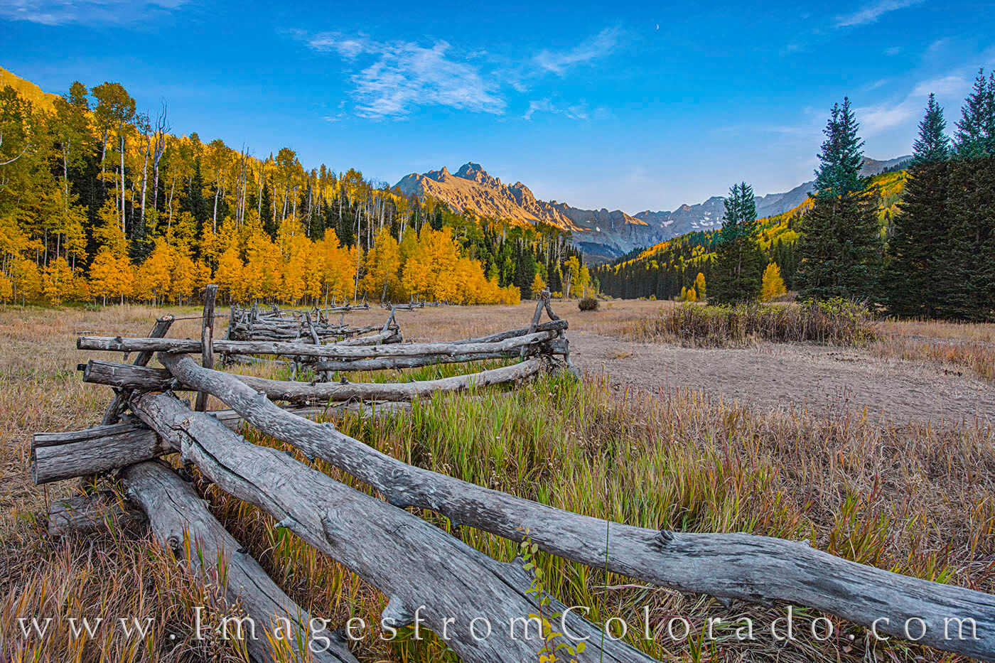Fall along CR 7 and the Dallas Divide 103-1 An old wooden fence acts as a leading line drawing my focus to the golden aspen trees of Autumn and the towering 14,000’ peak...