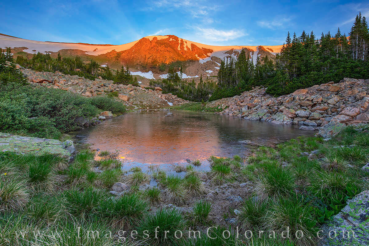 Frozen Pond in Morning Light 703-1 Morning light shines its warming glow atop a ridge near Vasquez Peak on Berthoud Pass. At about 12,000’ in elevation, the reflection...