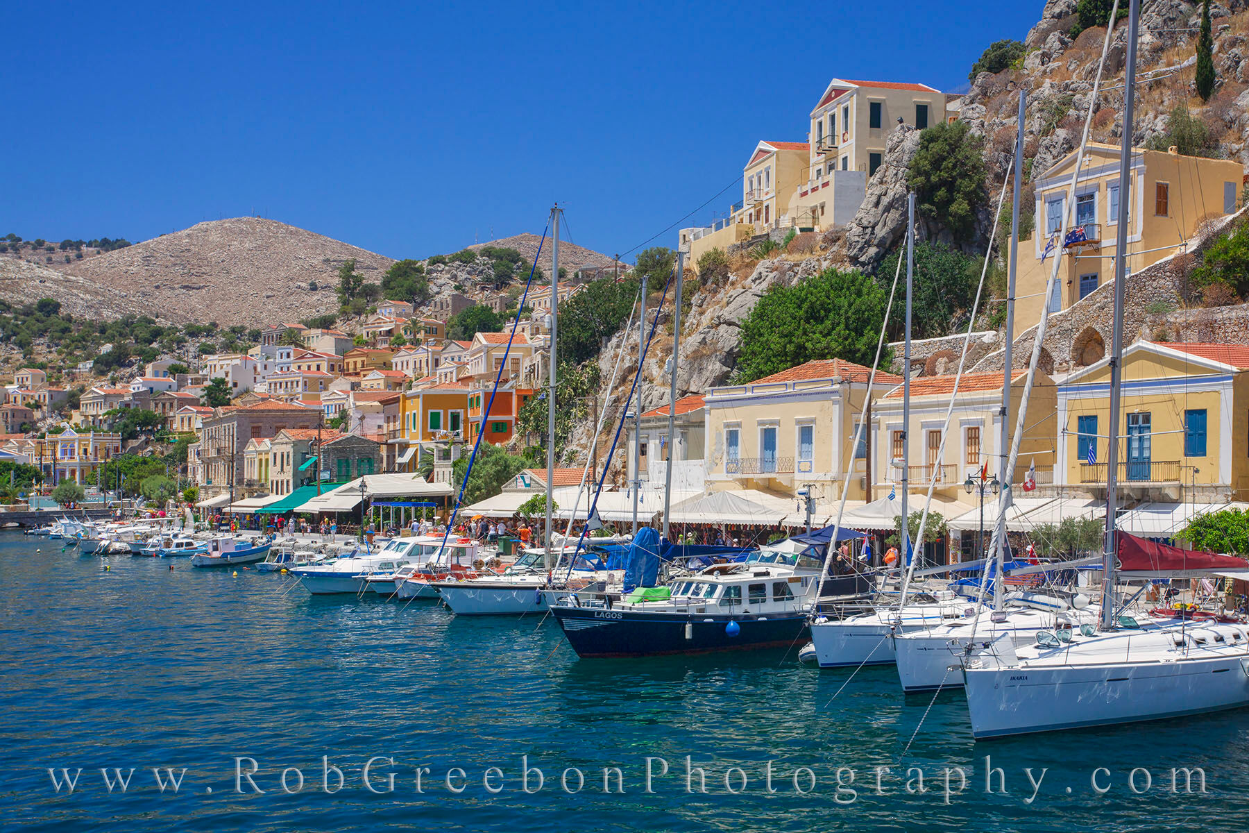Greece - Symi Port Afternoon 1 With a population under 3,000 people, the island of Symi is a quiet respite from the real world. Located in the Dodecanese island...