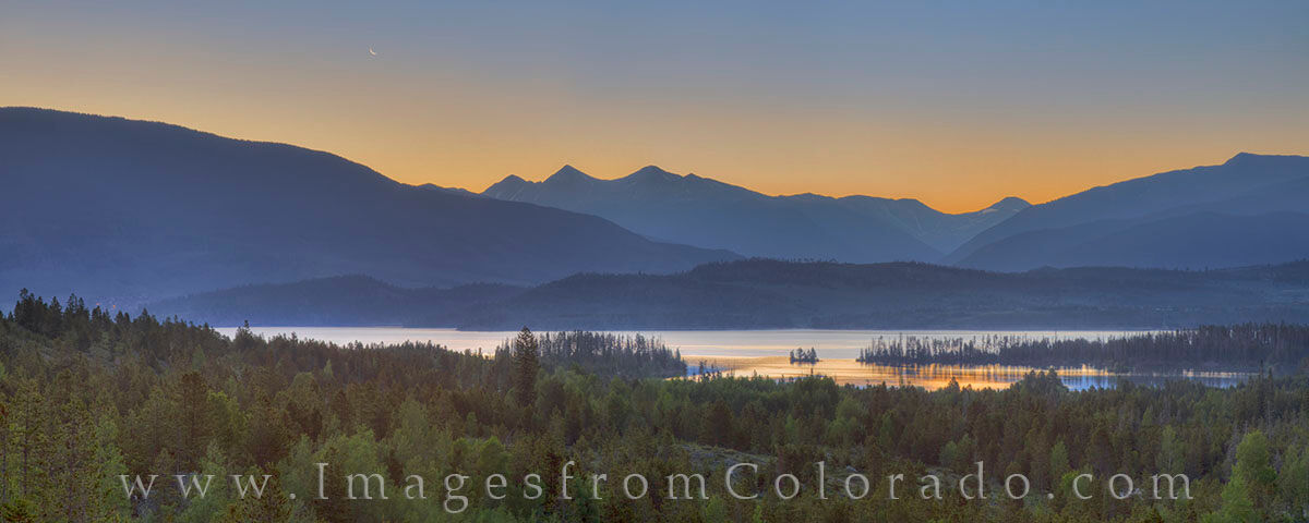 Lake Dillon Before Sunrise Panorama 1 This panorama shows Lake Dillon at sunrise as a sliver of a crescent moon rises in the east just ahead of the sun. The lake below...