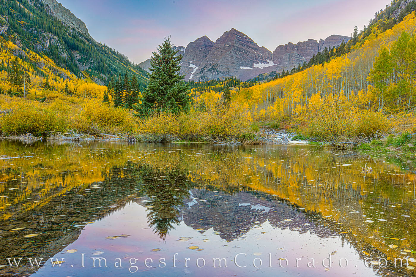 Maroon Bells October Sunset 102-1 The muted colors of an October sky usher in the evening over the Maroon Bells and a mountain of golden aspen trees. In the foreground...