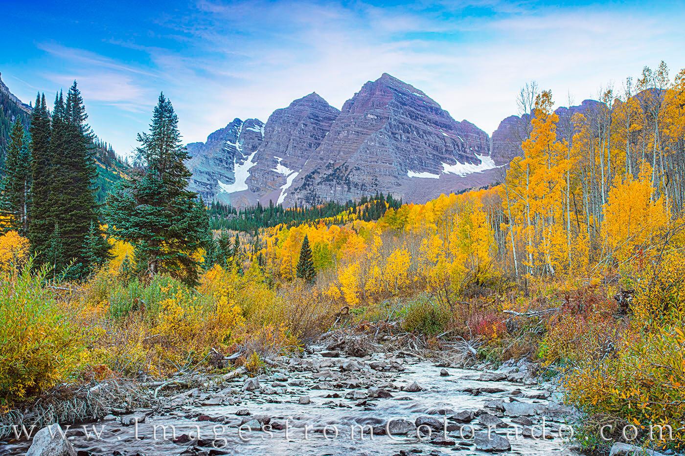 Maroon Bells and West Maroon Creek Autumn Evening 103-1 West Maroon Creek flows down from the higher elevations as the Maroon Bells Wilderness area shows off its fall colors. In the...