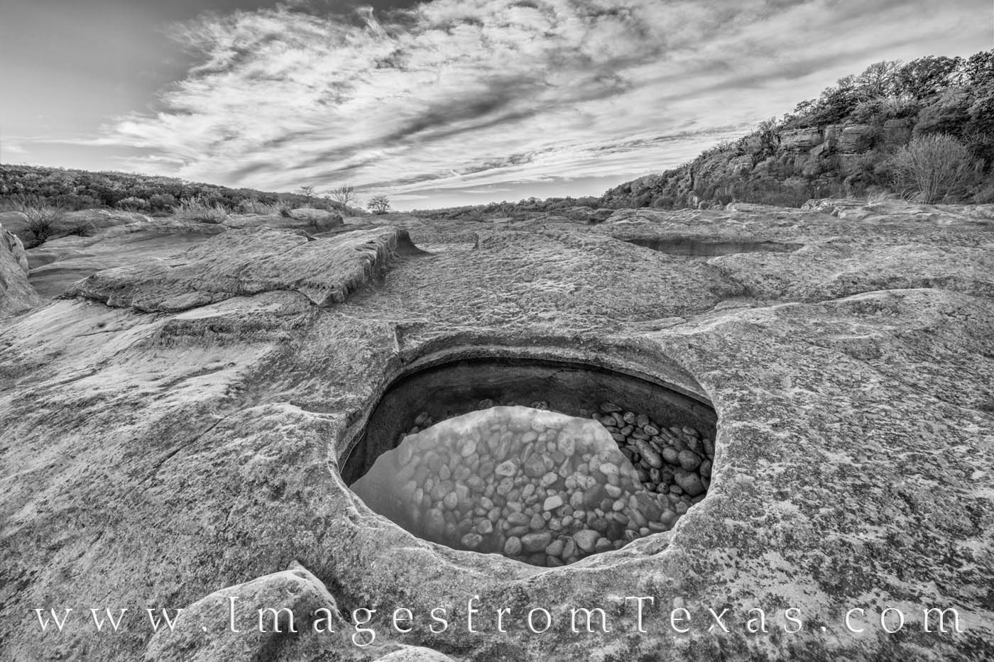 Pool at Pedernales Falls 315-2 Black and White A clear vernal pool at Pedernales Falls State Park shows small pebbles and rocks beneath a beautiful evening sky. The Hill Country...