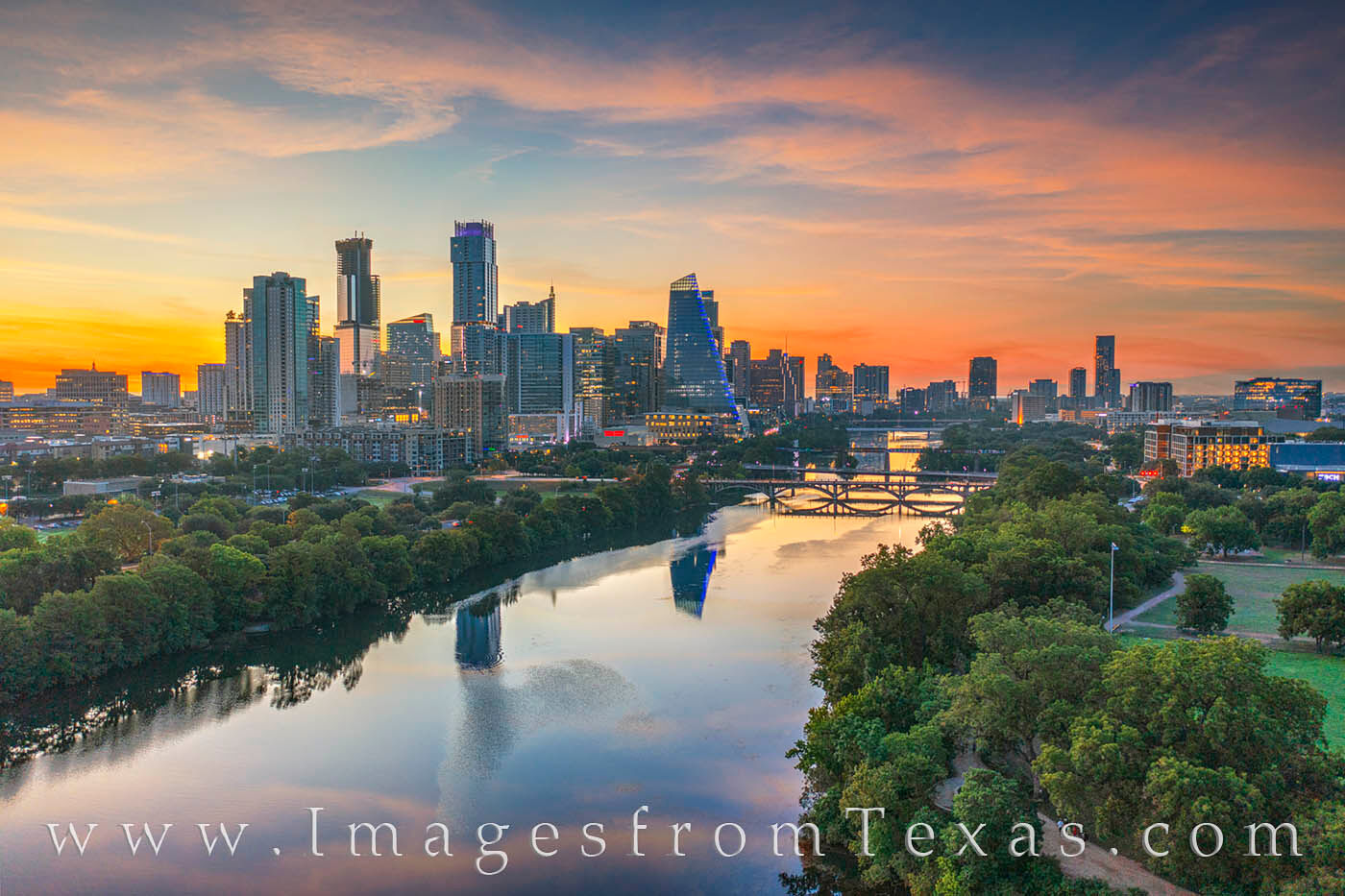 Sunrise Austin from the Air 827-1 From high above the trees along the Zilker Park Hike & Bike Trail, the Austin skyline rises into a beautiful morning sky of pastels...