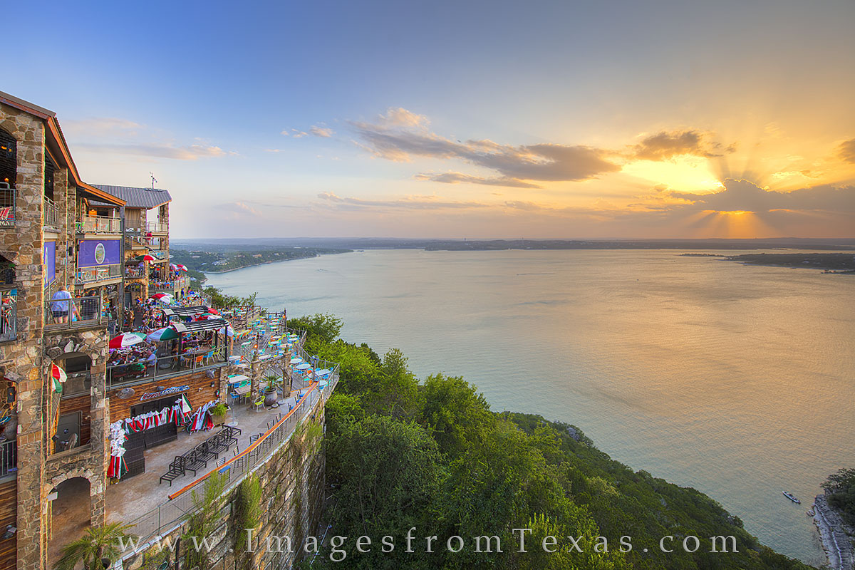 The Oasis - Austin, Texas 1 The sun shines from behind fading clouds on a summer night as folks at The Oasis, a popular Austin, Texas, restaurant, enjoy...