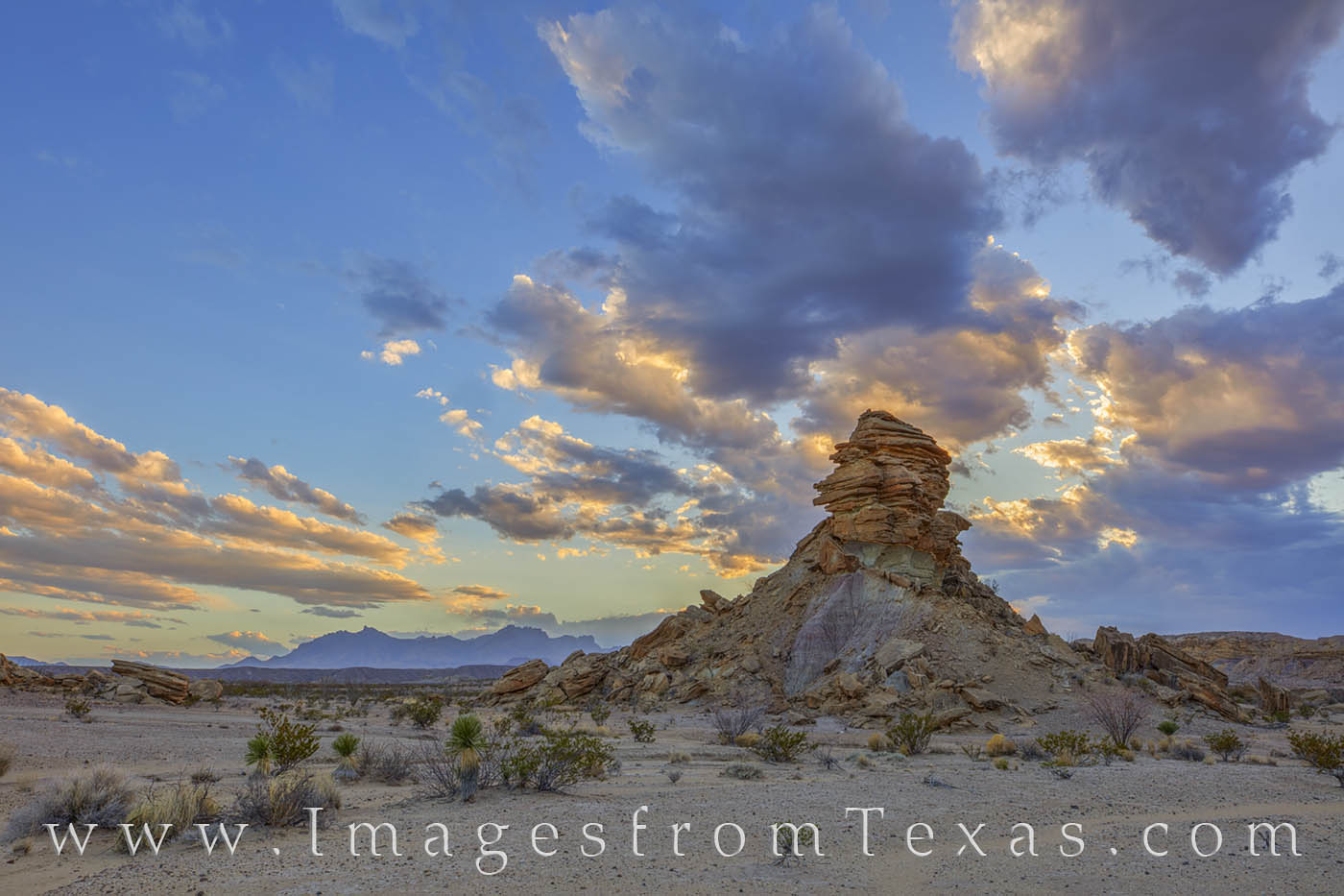 Tornillo Flats Hoodoo at Sunset 115-2 Evening clouds roll across the Chihuahuan Desert on a cool evening. In the distance, the Chisos Mountains rise into the west...