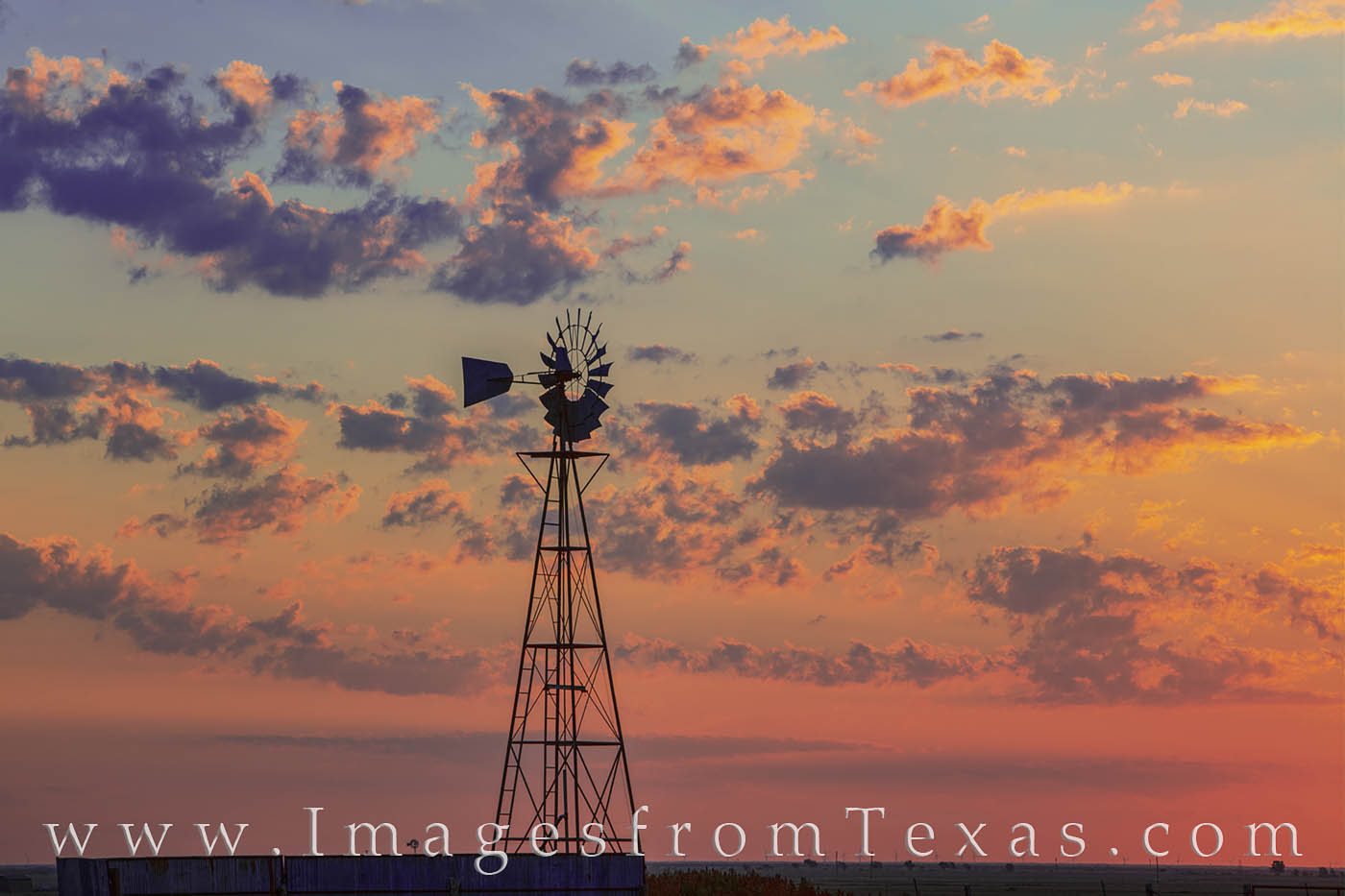 Windmill on a West Texas Sunrise 724-1 On an unusually cool summer morning between Canyon and Palo Duro, a windmill stands still on a beautiful and colorful sunrise...